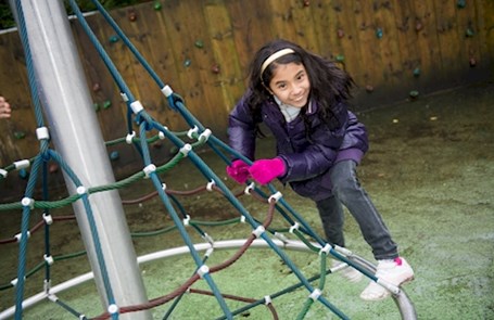 Playground image, girl on a climbing frame